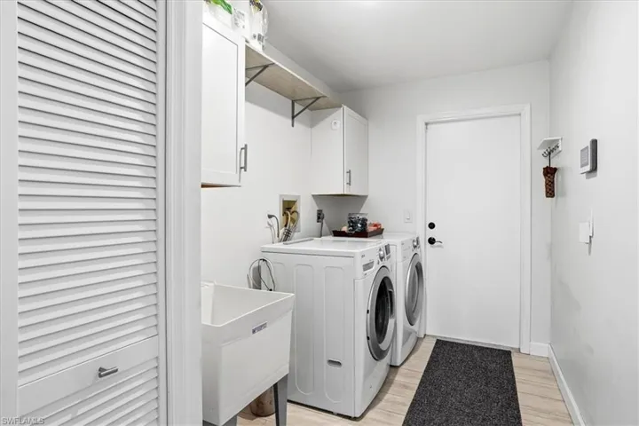 Bedroom with access to exterior, light wood-style flooring, a ceiling fan, and a closet