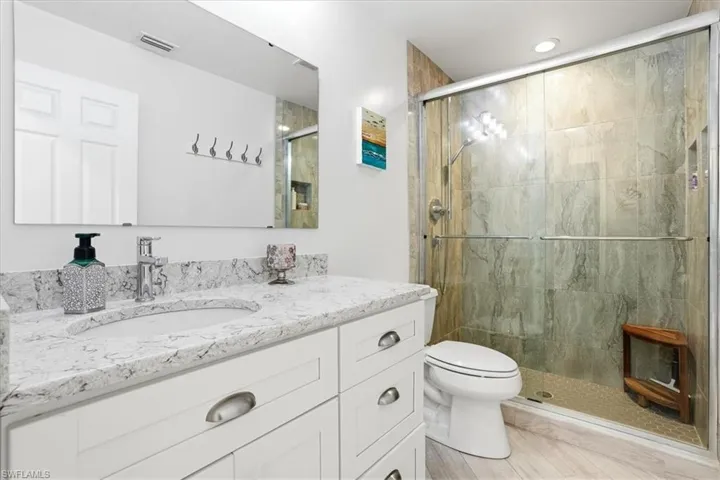Bathroom featuring vanity and a stall shower