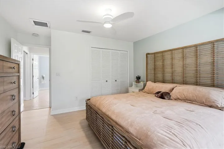 Bedroom with a closet, light wood-type flooring, and ceiling fan