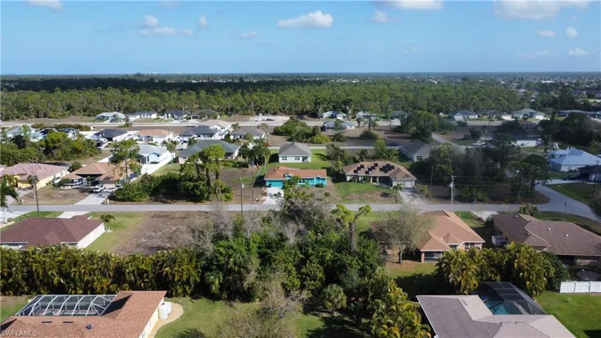 Aerial view of residential area with a forest
