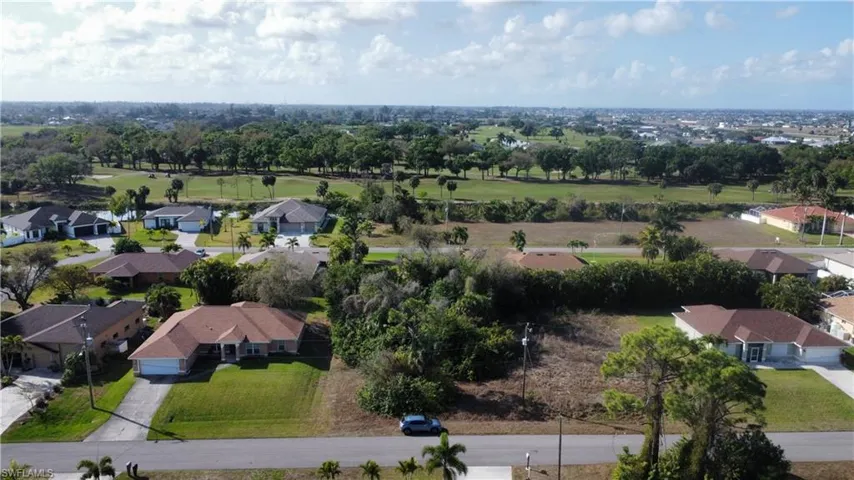 Aerial perspective of suburban area featuring a golf course