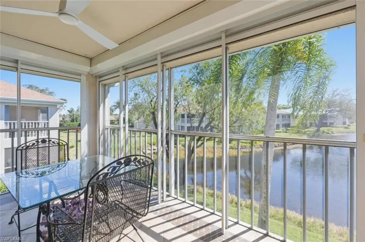 Sunroom / solarium featuring a water view