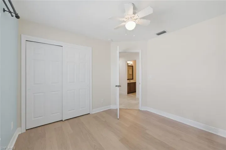 Unfurnished bedroom featuring light wood-type flooring, a ceiling fan, and a closet