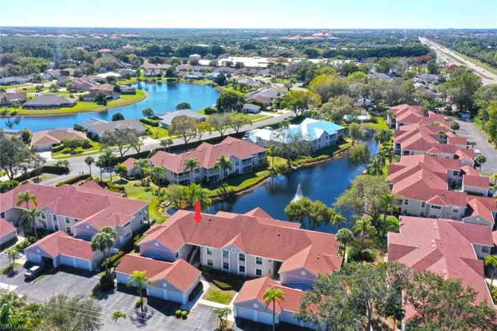 Aerial view of residential area featuring a nearby body of water