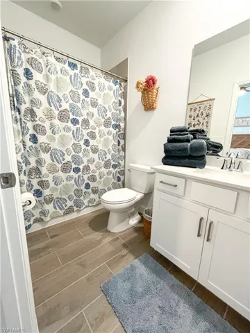 Bathroom featuring vanity, tile finish floors, and a shower with shower curtain