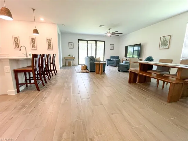 Living room featuring a ceiling fan and light tile flooring
