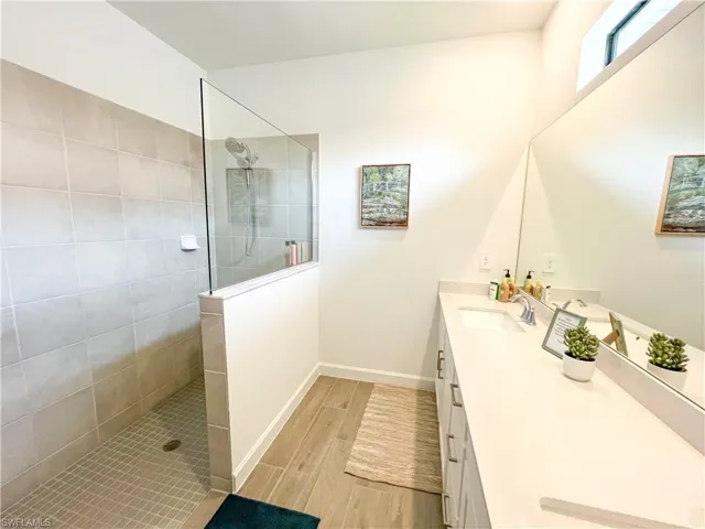 Full bathroom featuring vanity, tile finished floors, and walk in shower