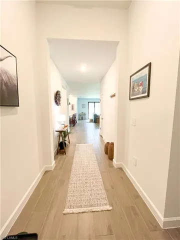 Hallway with light tile-type flooring