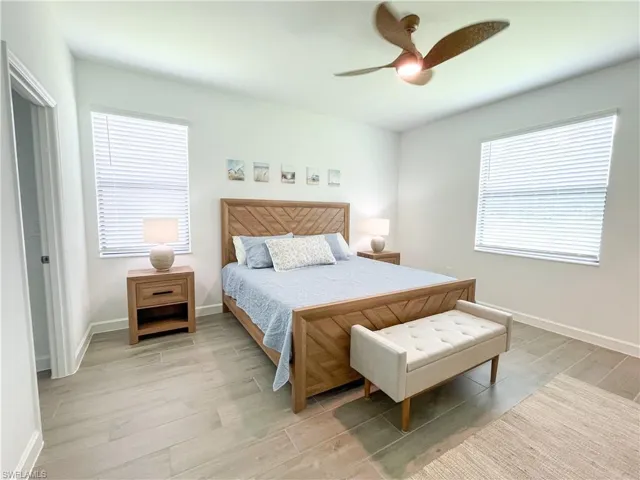 Bedroom featuring light tile floors and ceiling fan