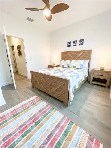 Bedroom with ceiling fan and tile finished floors