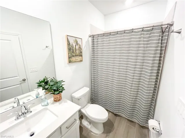 Bathroom featuring vanity, tiled floors, and a shower with shower curtain