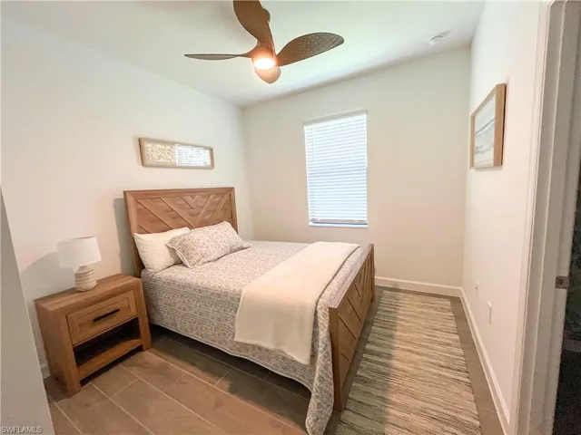 Bedroom featuring ceiling fan and baseboards