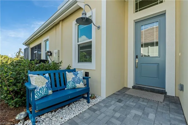 View of exterior entry featuring a patio and stucco siding