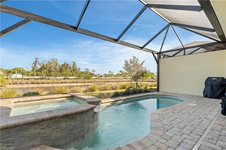 Relaxing pool / spa with a lanai, area for grilling, a patio area, and a sunroom