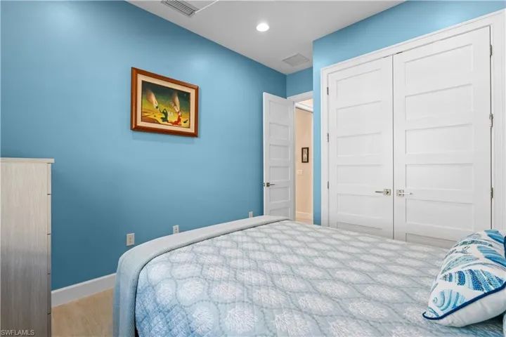 Bedroom with wood finished floors and a closet