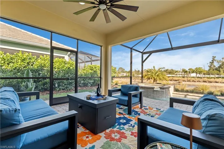 Sunroom featuring a ceiling fan, an outdoor hangout area, and a patio
