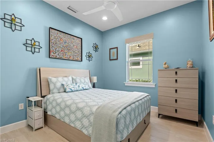 Bedroom with light wood-type flooring, ceiling fan, and recessed lighting