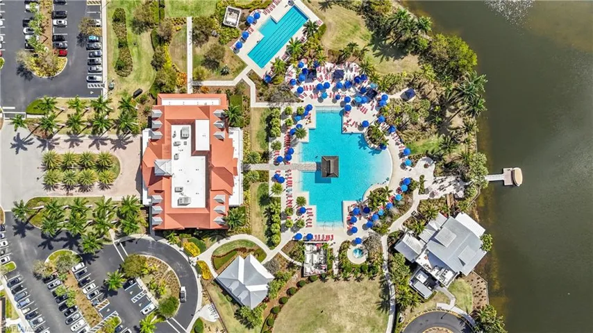 Drone / aerial view of a pool and a nearby body of water
