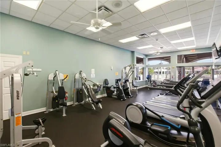Clubhouse Gym with a ceiling fan and a paneled ceiling