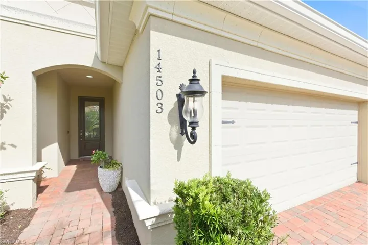 Doorway to property featuring stucco siding