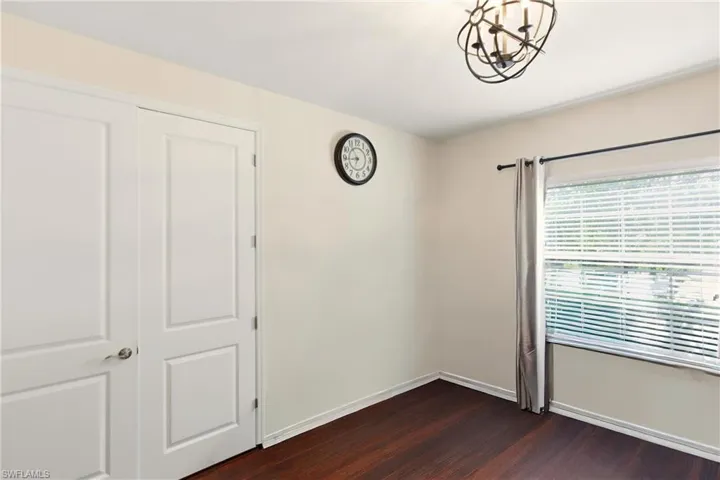 Home office featuring dark wood-style tile floors and French Doors
