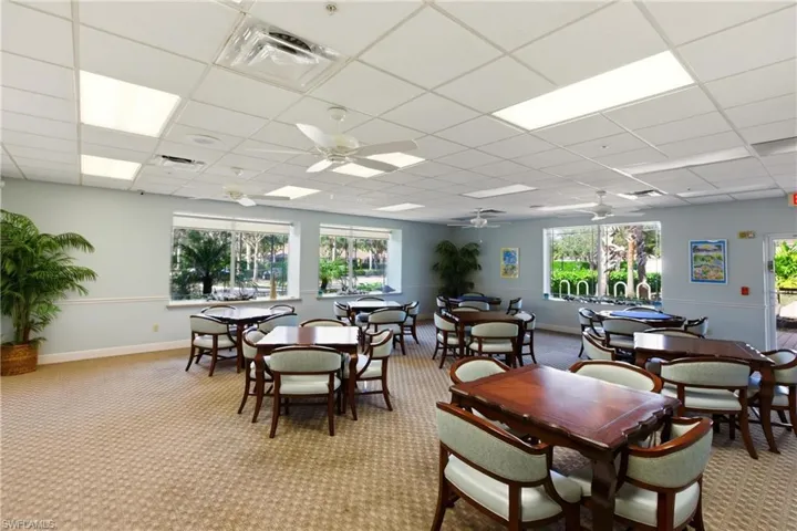 Clubhouse Game/Card room featuring a paneled ceiling, plenty of natural light, carpet, and a ceiling fan