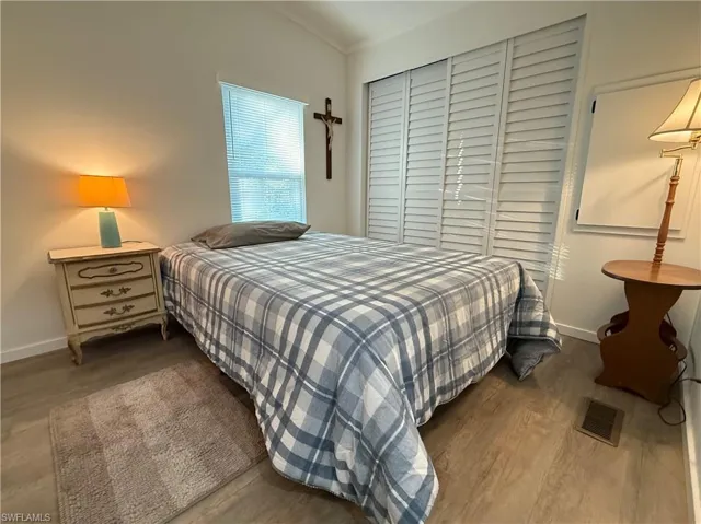 Bedroom featuring hardwood / wood-style floors and lofted ceiling