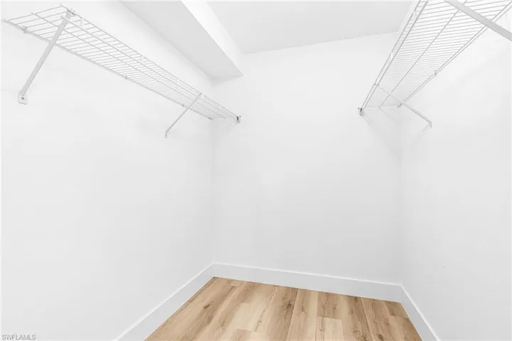 Spacious closet with light wood finished floors