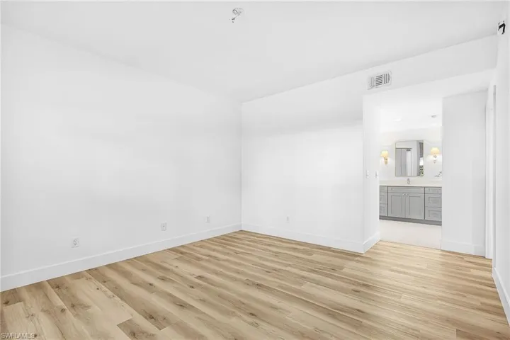 Spare room featuring light wood finished floors and baseboards
