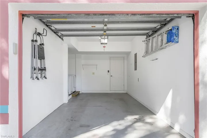 Garage with electric panel and a garage door opener