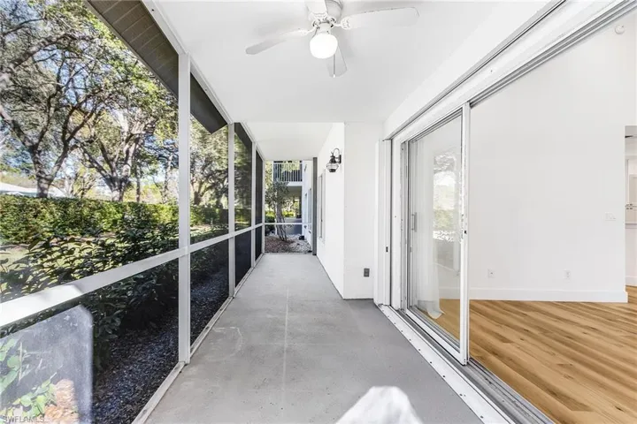 Unfurnished sunroom with plenty of natural light and a ceiling fan