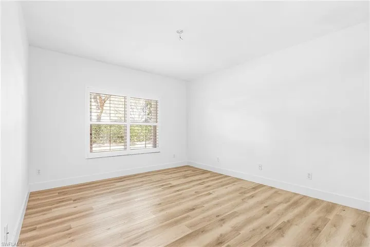 Spare room featuring light wood-style floors and baseboards