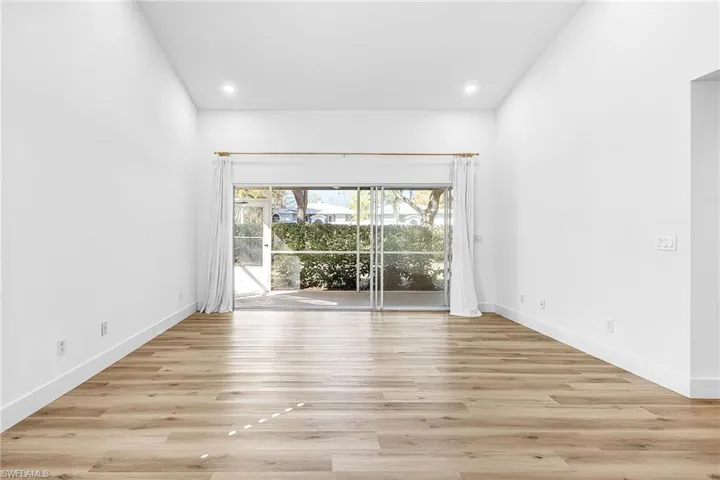 Empty room featuring light wood finished floors and recessed lighting
