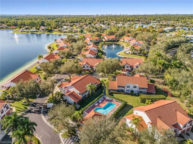 Aerial view of residential area featuring a nearby body of water