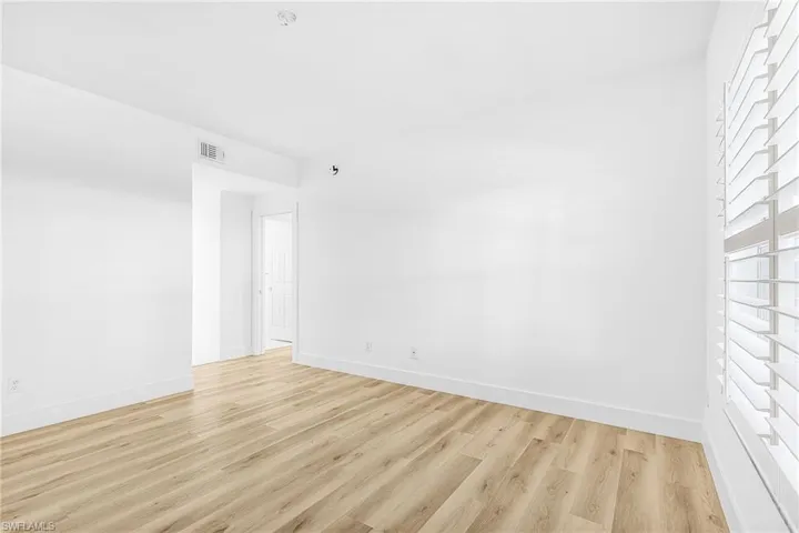 Spare room with light wood-style floors and baseboards