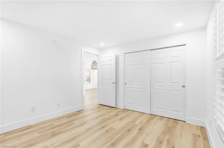 Unfurnished bedroom with light wood-style floors, a closet, and recessed lighting