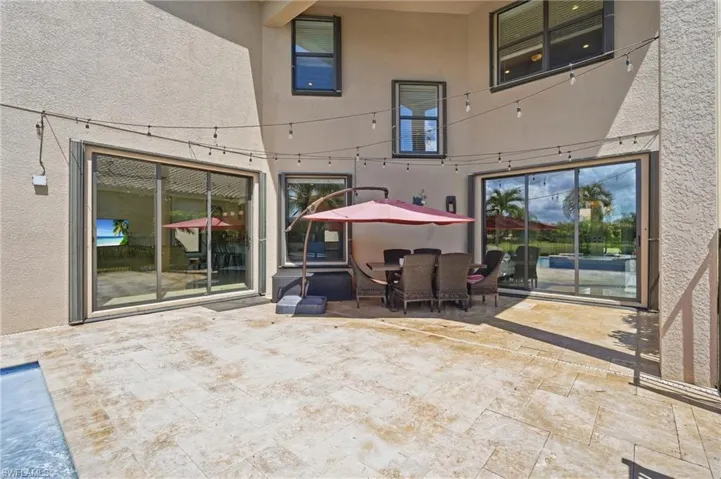 Outdoor living area overlooking the pool and lanai.