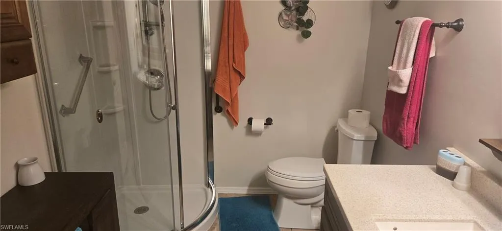 Full bath with vanity and a shower stall