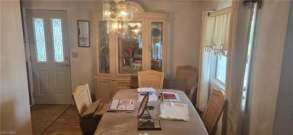 Tiled dining area featuring a chandelier