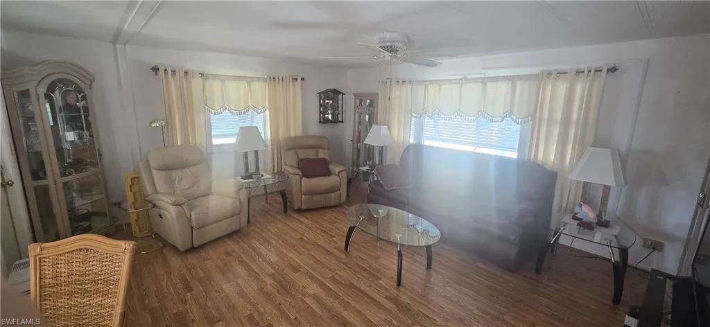 Living area featuring a ceiling fan and wood finished floors