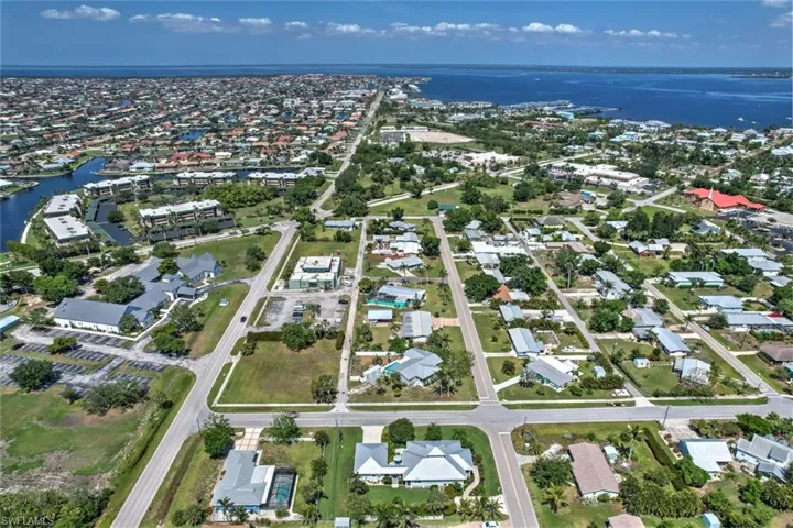 View of property location featuring a large body of water and nearby suburban area