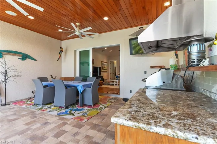 View of patio / terrace with area for grilling, ceiling fan, and outdoor dining area