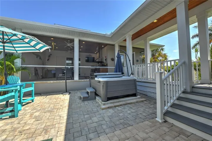 View of patio with a sunroom
