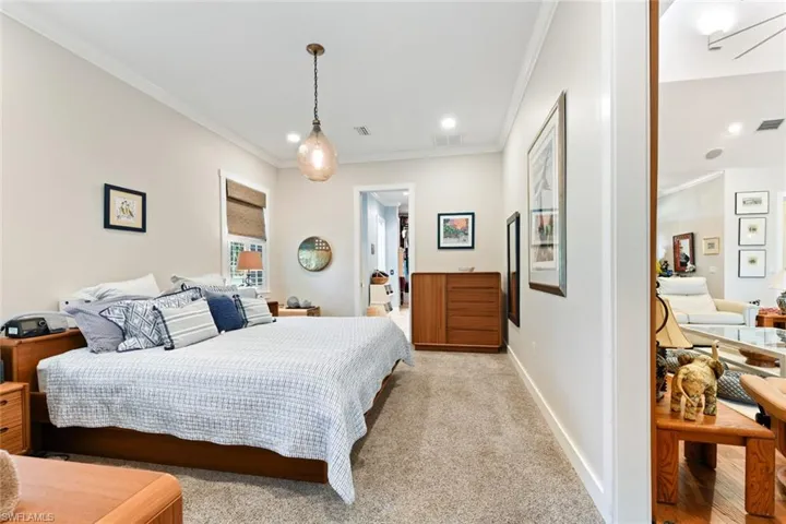 Bedroom featuring ornamental molding, light carpet, baseboards, and recessed lighting