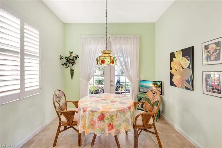 Dining room featuring french doors and light tile patterned floors