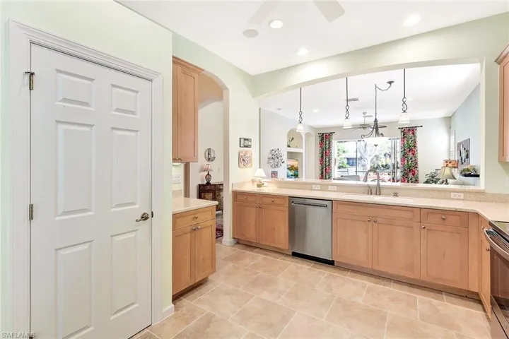 Kitchen featuring sink, decorative light fixtures, kitchen peninsula, ceiling fan, and stainless steel appliances
