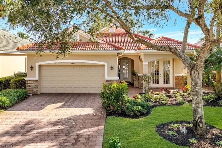 Mediterranean / spanish house featuring a garage, a front lawn, and french doors
