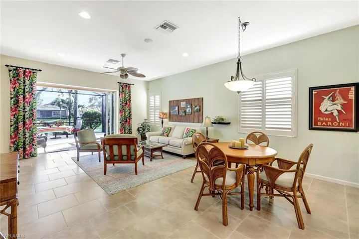 Dining space with light tile patterned floors and ceiling fan