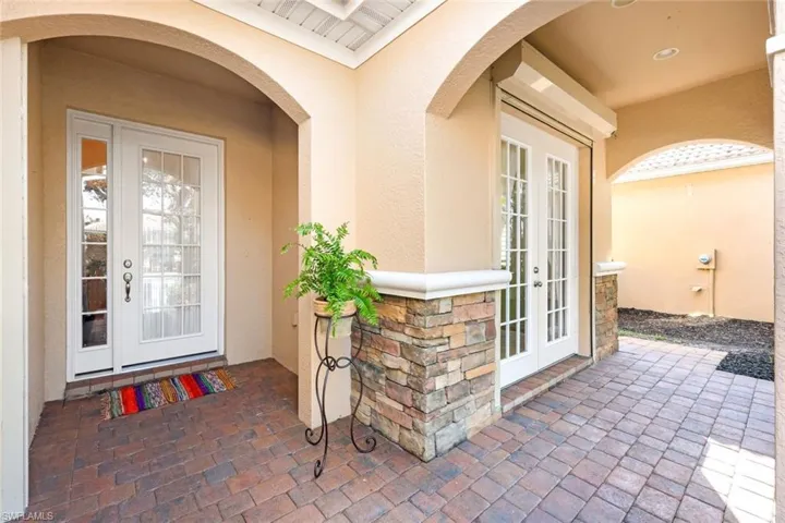 View of exterior entry with a patio area and french doors