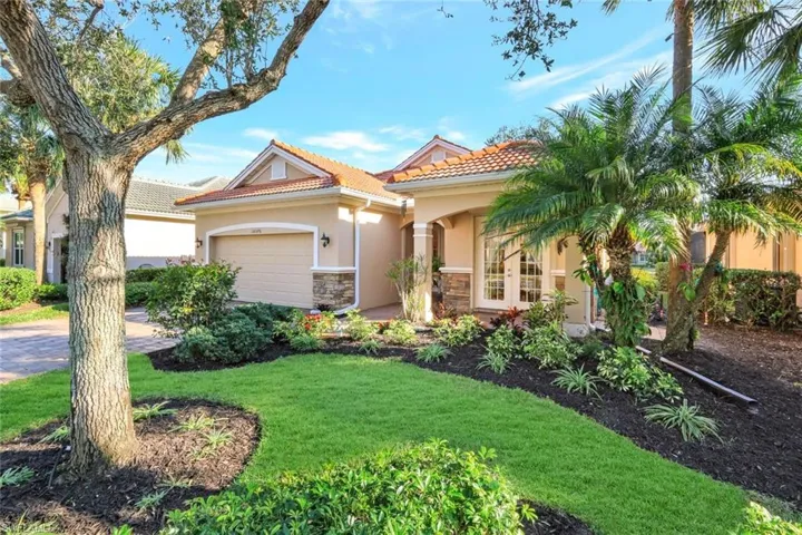 View of front of home featuring a garage and a front lawn